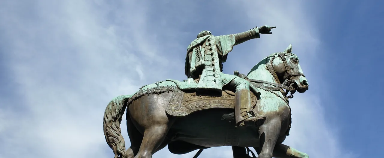 A close view of the equestrian monument against the sky.